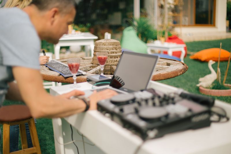 a man preparing the party music