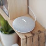 google home mini on a wooden floating shelf