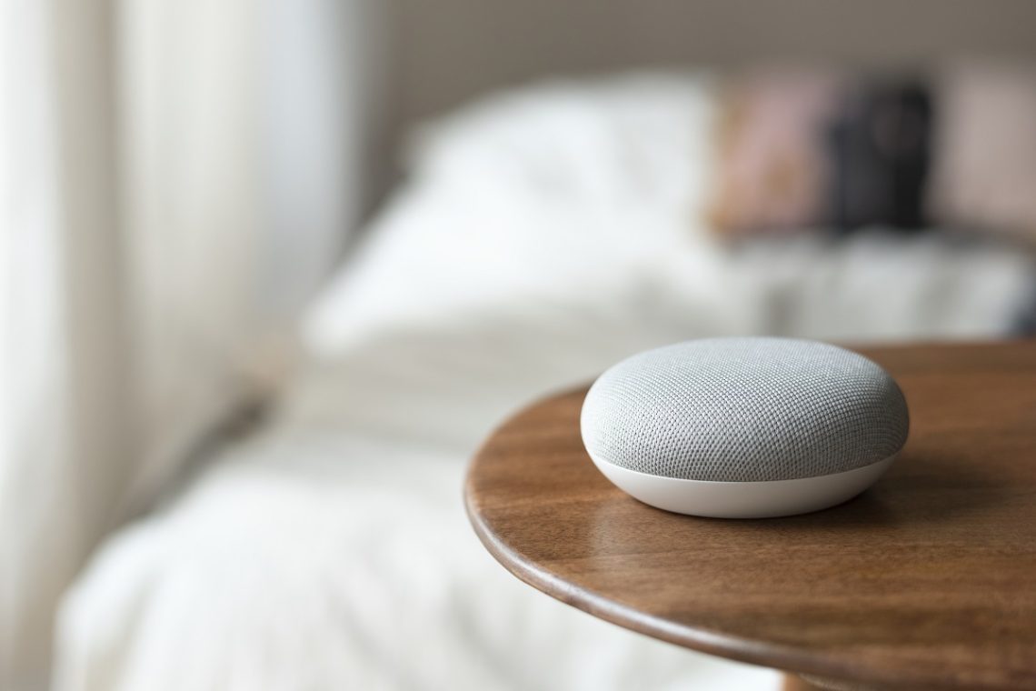 google home mini on a wooden table